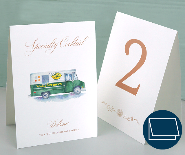 Two tent folded cards set as a table number and a specialty cocktail sign