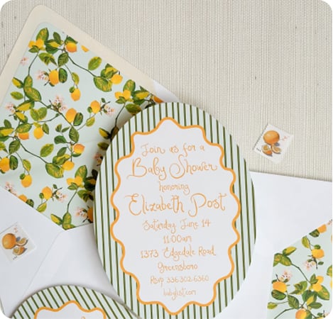 A baby shower invitation with a white envelope. The envelope features a unique liner with a lemon-and-leaf pattern to match the invitation design. A baby shower invitation with a white envelope. The envelope features a unique liner with a lemon-and-leaf pattern to match the invitation design.